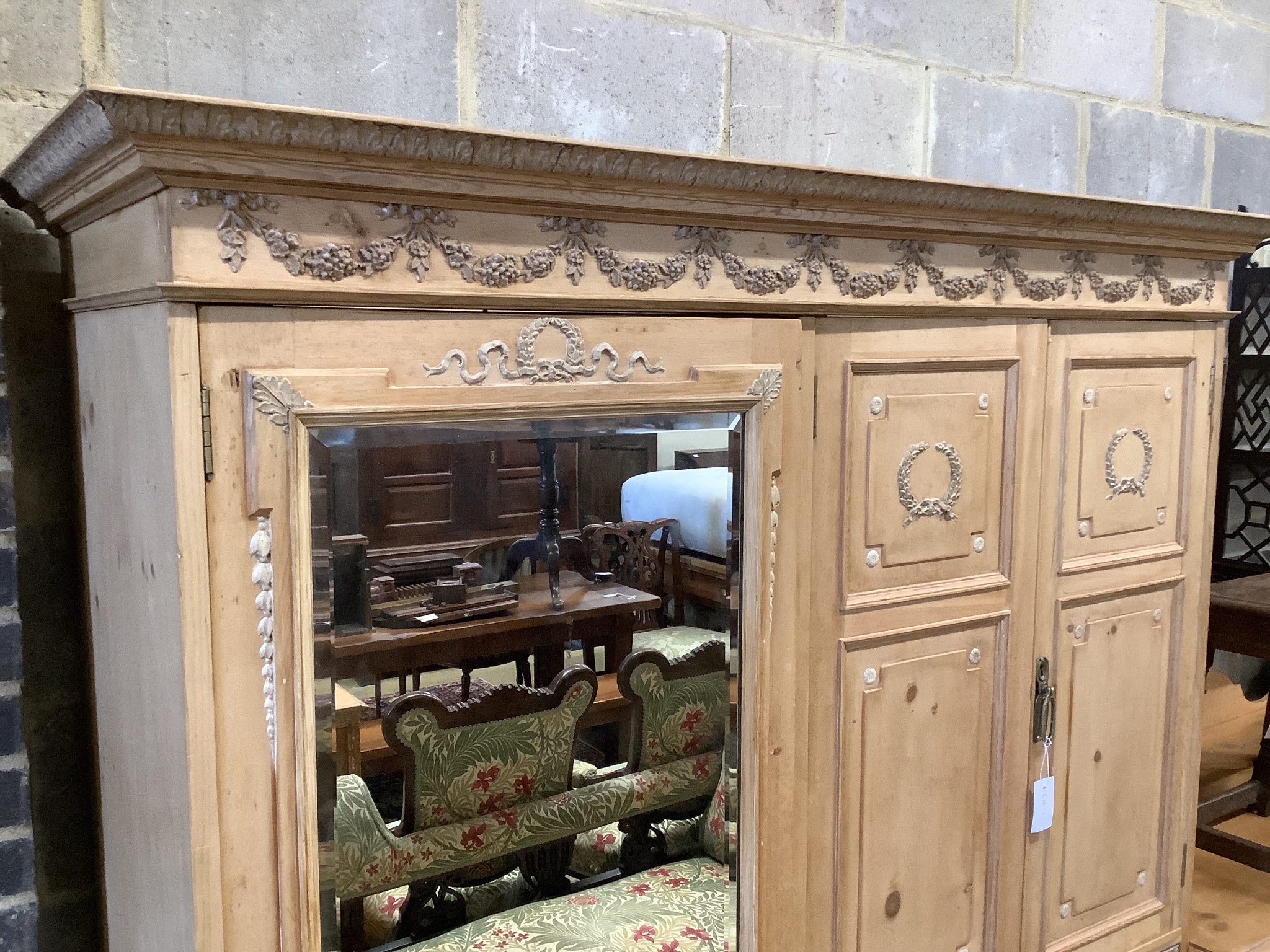 An Edwardian pine compactum wardrobe retailed by Maple & Co., length 113cm, depth 60cm, height 196cm